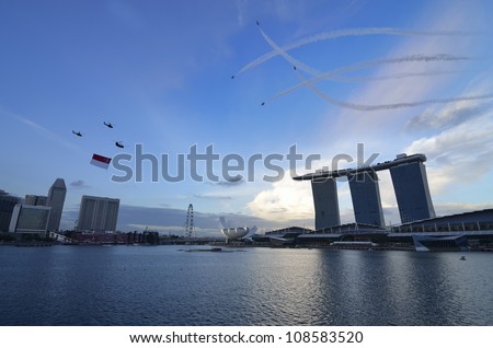 SINGAPORE - JULY 21: helicopter flying Singapore national flag at National Day Parade Singapore 2012 Combined Rehearsal on July 21, 2012 in Singapore.