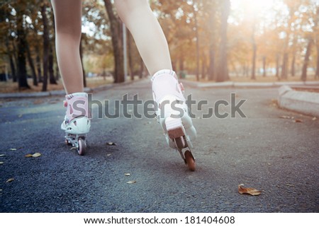 Legs of teenager having roller skate exercise in public park