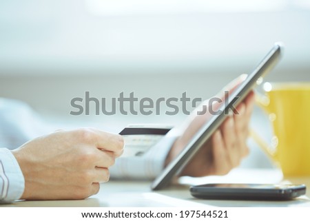 Human hands with tablet PC and credit card during lunch