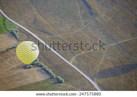 Air balloon flying above the land. Horizontal photo