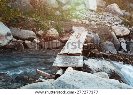 Wooden bridge over small river. Horizontal photo