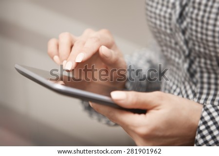Womanworking with digital tablet. Close-up horizontal photo