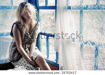 Rural lady sitting at the window