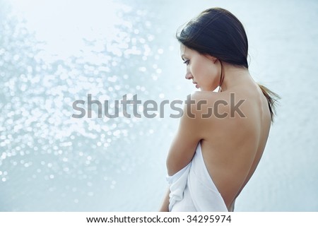 Sad lady with naked back on the water background