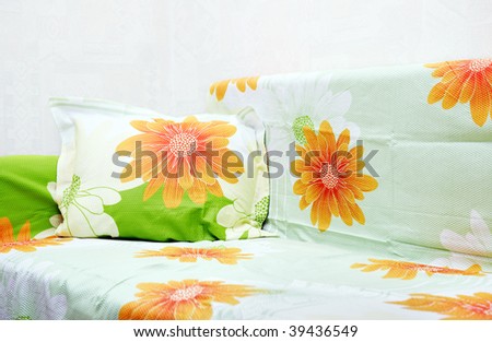 Sofa indoors with colorful bed-clothes