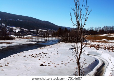 A view of Winter homes  on the mountain slope with snow on the ground on a fine clear winter day.