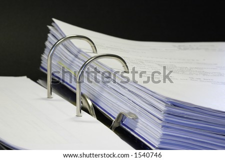 open binder with invoice and office items