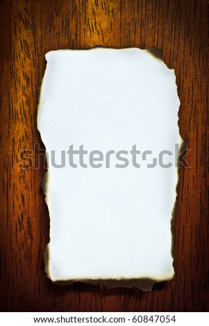 Burn edge blank paper on brown wood texture (mahogany)