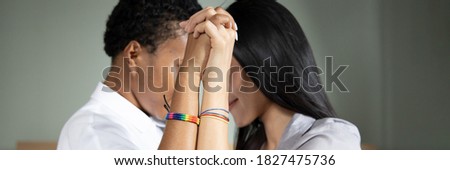 Black african LGBT woman hand in hand with asian LGBT woman, gay pride concept, banner 商業照片 © 