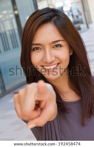 smiling woman point finger at you, positive mood
