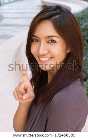 woman showing 1 finger, smiling to you
