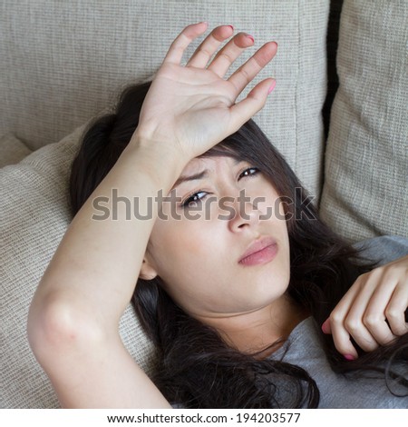 sick woman, resting and lying down in home, indoor scene