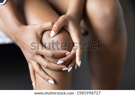 Black African young woman having knee joint pain or knee injury problem, concept of knee joint surgery or orthopedics treatment Photo stock © 
