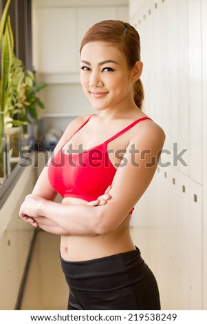 happy, smiling fitness woman in gym locker room