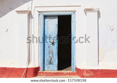 Front view on the blue ancient door.