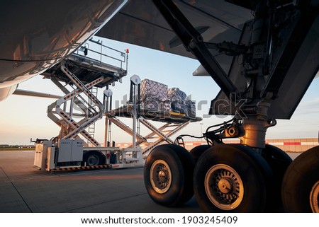 Loading of cargo containers to plane at airport. Ground handling preparing freight airplane before flight.  Zdjęcia stock © 