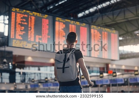 Similar – Image, Stock Photo Passenger looking at flight information board.