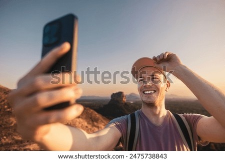 Similar – Man photographing landscape from observation deck