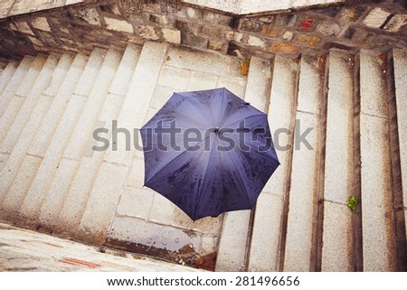 Rain in the city - Man with blue umbrella