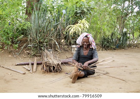UKUNDA, KENYA - APRIL 2: A portrait of real life in a kenyan village. Woman making roof cover on April 2, 2011 in Ukunda, Kenya
