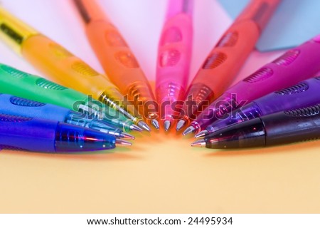ten color pens on yellow paper - closeup