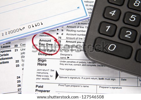 Tax document - Amount you owe on tax return with checkbook and calculator