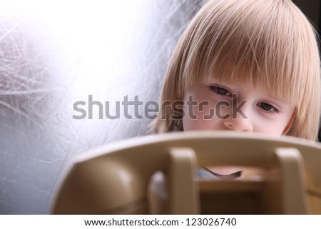 Boy with vintage telephone waiting for a call