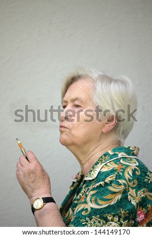Old woman smoking portrait