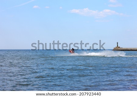 Man driving a scooter in the sea