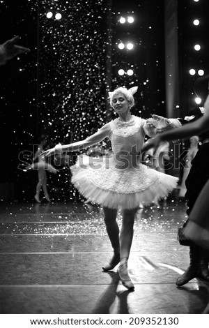 Ballet dancer on stage, snowing; monochrome
