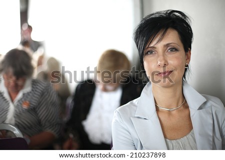 Beautiful mid-aged woman portrait at conference hall
