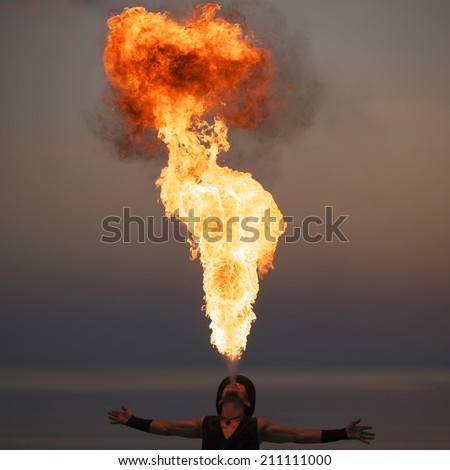 Fire-breathing show outside; fire pillar