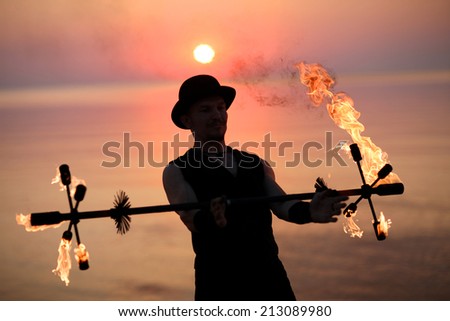 Performer with a burning torch; special equipment for fire show
