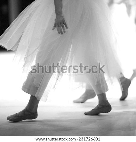 Ballerina wearing fluffy skirt over pants, monochrome