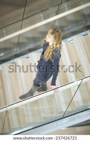 Attractive woman coming down the stairs, top view