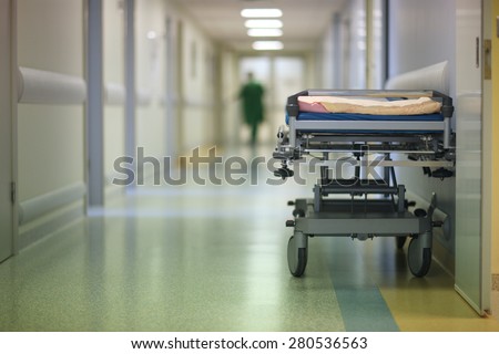 Empty hospital cot in a corridor