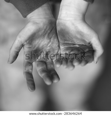 Dirty hands of a child begging