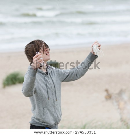 Teenager having trouble launching the kite