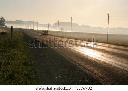 car driving along foggy scenic road