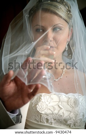 Young Bride drinking wine on wedding