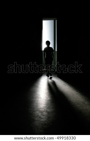 Teenager silhouette with shadow in dark background