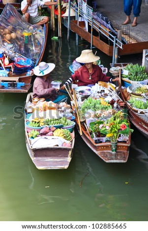 BANGKOK  MARCH 18: Wooden boats busy ferrying people at Amphawa floating market on March 18, 2012 in Bangkok. A traditional popular method of buying and selling still practiced in Amphawa Thailand.