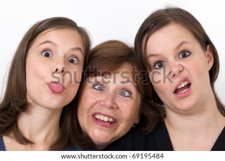 Mother and her daughters looking silly while goofing around.