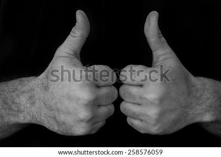 Black and white image of two hands giving a thumbs up