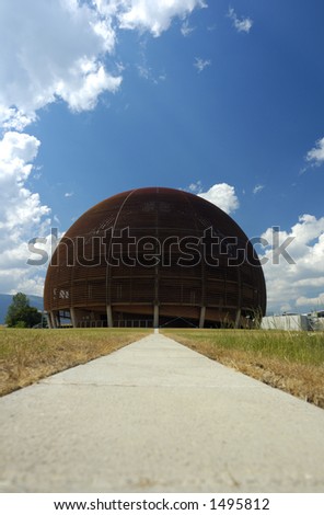 A wooden dome (the Globe of Science and Innovation at the European particle research laboratory CERN, Switzerland) rises against a blue sky with a few cumulus clouds.