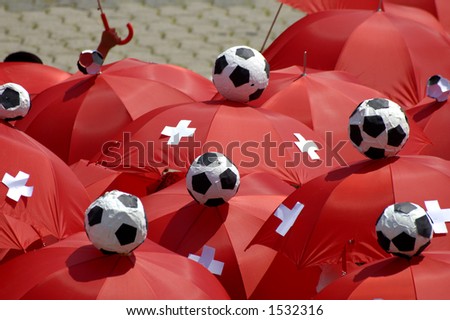 The red umbrellas of a group of Swiss football supporters during the football World Cup, 2006.