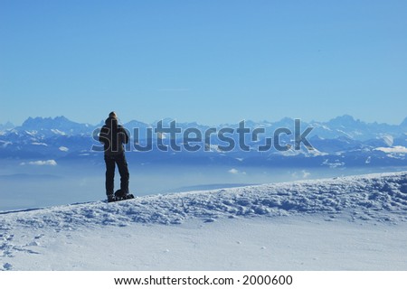 A skier in the Jura mountains gazes across to the French Alps. The jagged row of peaks to the left of her head are the Dents du Midi.