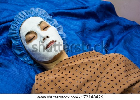 spa teen girl applying facial clay mask. Beauty treatments