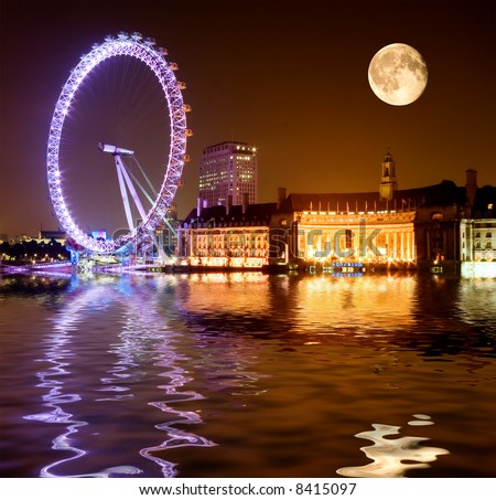 London Eye - dramatic night shot with full moon rising over the Thames