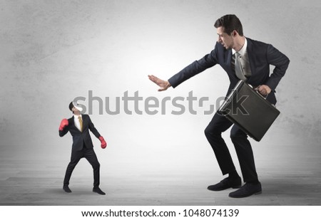 Big businessman being afraid of small masked businessman with box gloves in an empty room concept 商業照片 © 